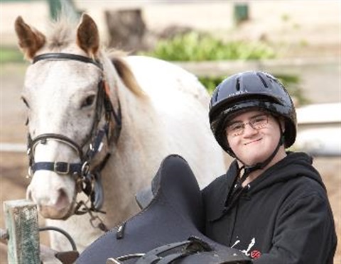 Young disabled man with horse